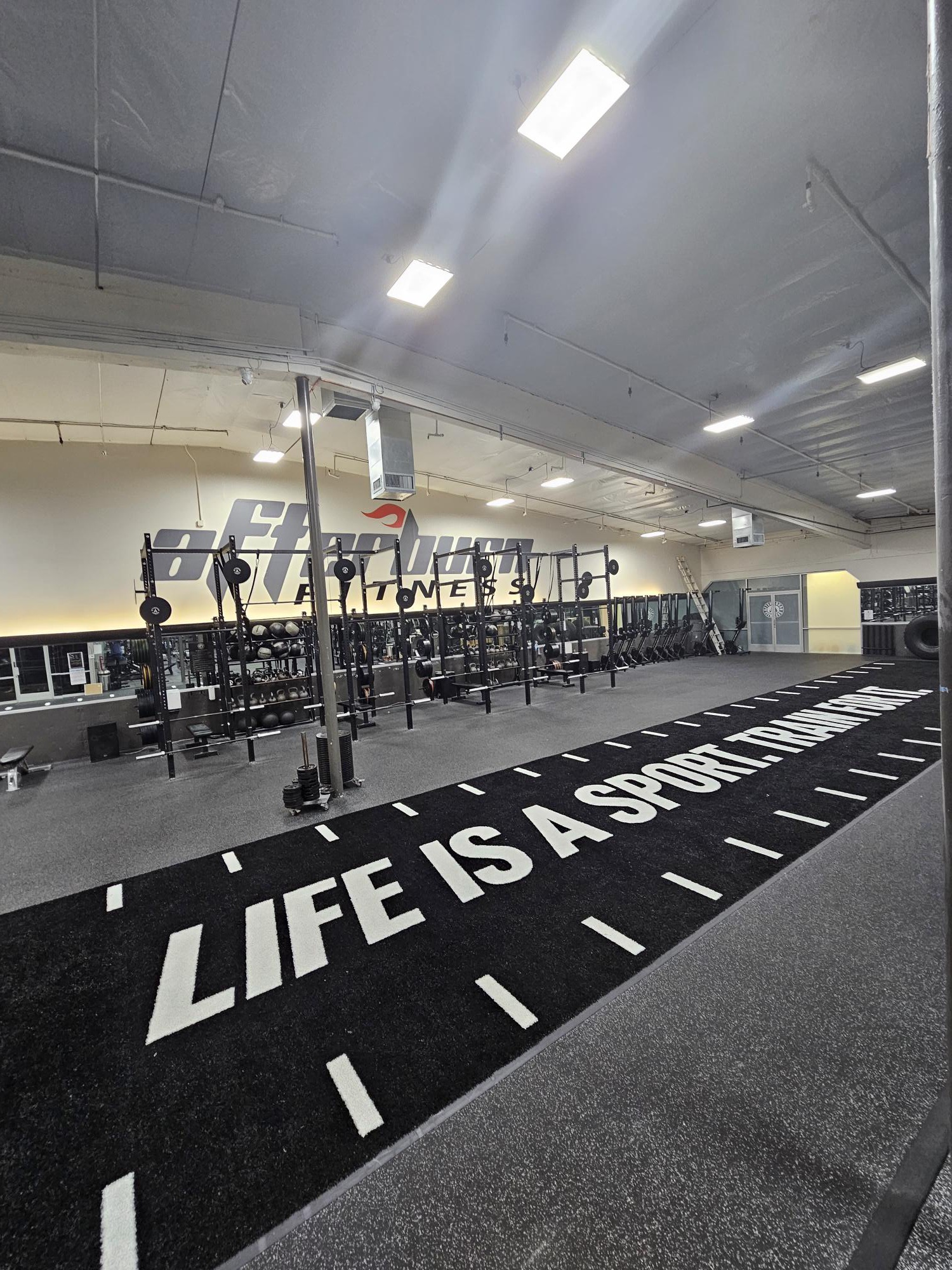 FFP turf sprint track with "Life Is A Sport" markings at AB Fitness