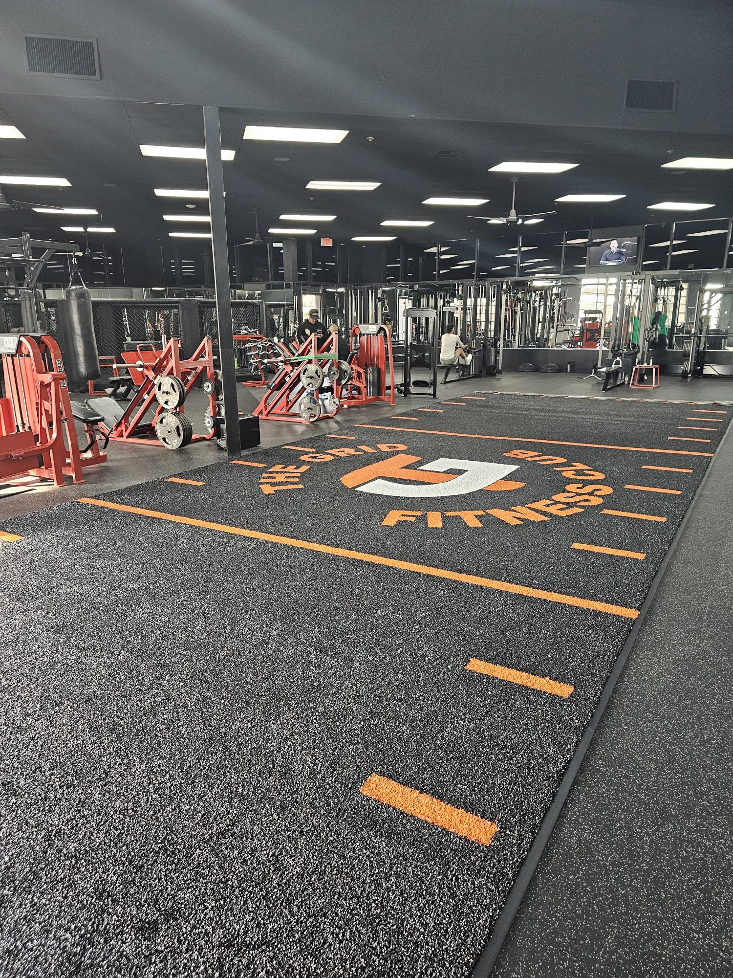 Black FFP turf with orange logo markings at The Grid Fitness Club